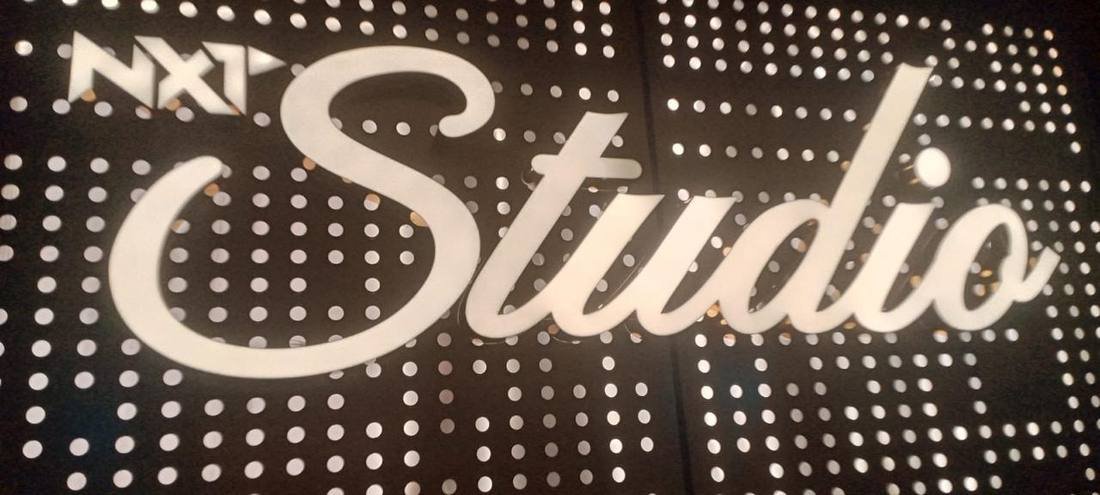 NXT Studio laser-cut backlit sign