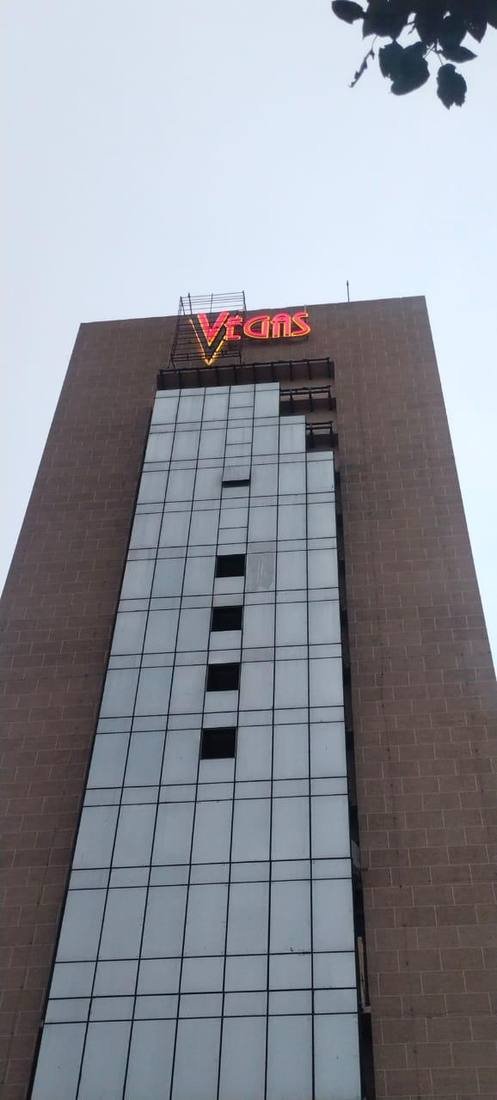 Vegas rooftop neon sign on tower